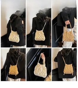 Detail view of handmade crochet crossbody bags in beige and khaki with fringe tassels