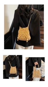 Detail of crochet cotton bucket bag with wooden beads and tassel accents on the side