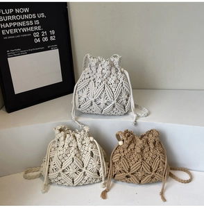 Detail view of handmade woven bucket bags in beige and khaki with geometric patterns