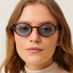 Retro oval tortoiseshell sunglasses with dark grey lenses and metal dot details
