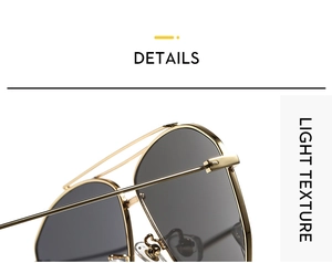 Detailed close-up of double-bridge gold metal frame and smoky gray lenses on aviator sunglasses
