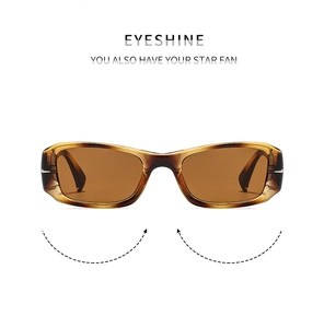 Macro shot of stylish amber rectangle sunglasses with metallic hinge and sleek finish