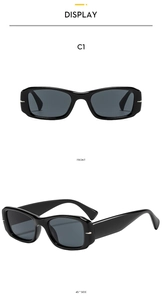 Detail view of square black sunglasses with silver metal accents and gray lenses