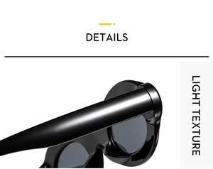 Close-up detail of glossy black oval sunglasses with wide temples and lightweight texture