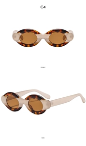 Detail of oval tortoiseshell sunglasses in brown and amber with translucent side temples