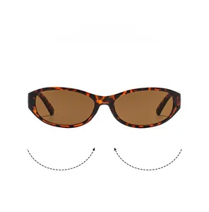 Detail shot of vintage oval sunglasses featuring tortoiseshell texture and brown lenses