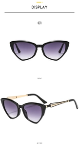 Detail of cat eye sunglasses with purple gradient lenses and hollow metal temples