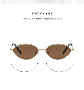 Close-up of golden oval metal frame sunglasses with brown polarized lenses for women