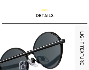 Close-up of retro oval sunglasses featuring glossy black frames and clear silicone nose pads