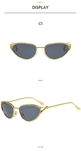 Detailed view of cat-eye sunglasses with gold metal frame and dark grey polarized lenses