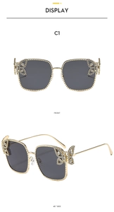 Front and side views of square crystal butterfly sunglasses with dark grey lenses