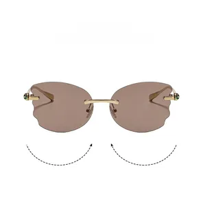 Detail of rimless sunglasses with wavy brown lenses and gold metal temples