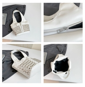 Macro view of white punk handbag details showing silver rivets and interior structure