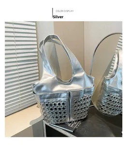 Detailed view of silver tote bag featuring metallic rivets and stylish side pocket design