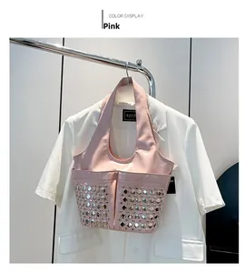 Detail of pink patent leather bucket bag with silver metal studs and front pockets