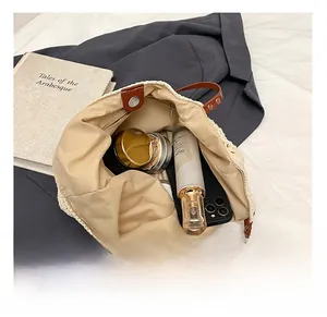 Spacious interior of beige handmade woven tote bag with magnetic clasp and leather trim