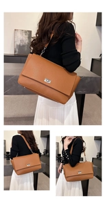 Detail of brown litchi pattern leather bag with silver twist lock and metal feet