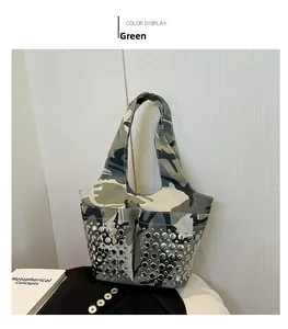 Detail of silver rivets and green camouflage texture on this stylish bucket bag