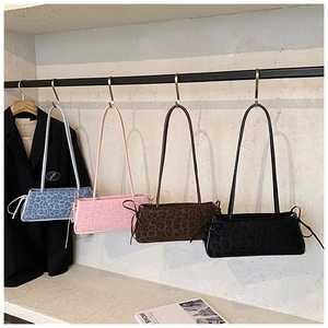 Detailed display of four leopard print underarm bags in blue, pink, brown and black
