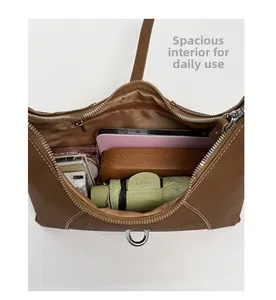Overhead view showing brown tote bag interior capacity with zip pocket and daily essentials