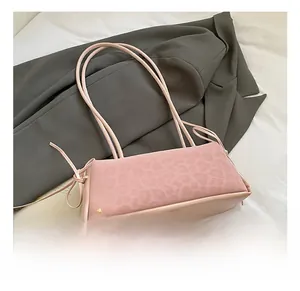 Detailed close-up of pink leopard embossed handbag with side decorative bow knots