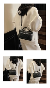 Three-way view of a black quilted square bag shown on stairs with a modern white outfit