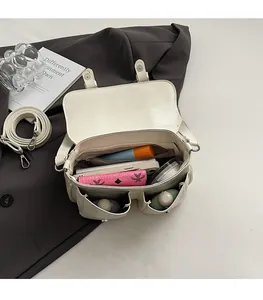 Internal view of cream crossbody bag showing large storage space for essentials