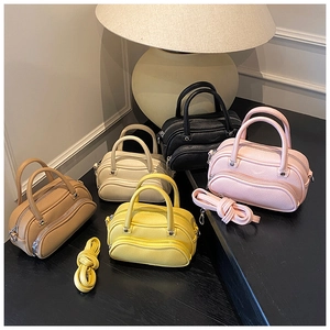 Detailed view of mini Boston bags in five colors with lychee texture and dual zippers