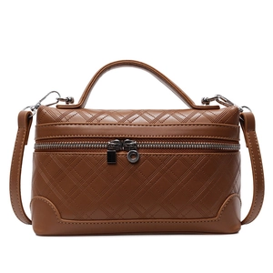 Caramel brown quilted leather crossbody handbag with top handle and silver zipper