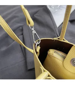 Detail of yellow lychee grain leather bucket bag with silver hardware and inner zipper