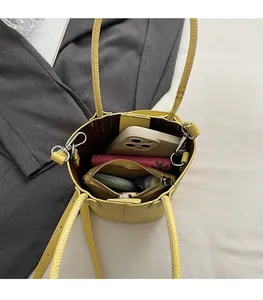 Detail showing the spacious interior compartment of the yellow lychee leather bucket bag