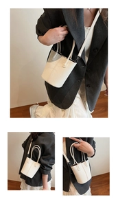 Macro detail of white lychee grain leather bucket bag with seamless stitching and texture