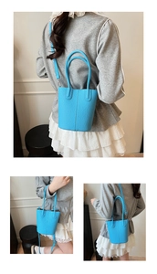 Detailed view of bright blue bucket bag showing lychee grain texture and circular handle