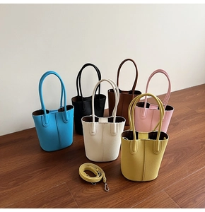 Litchi pattern leather mini bucket bags shown in six vibrant colors on a wooden floor