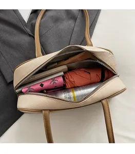 Top view of spacious interior of khaki tote bag showing umbrella and daily essentials