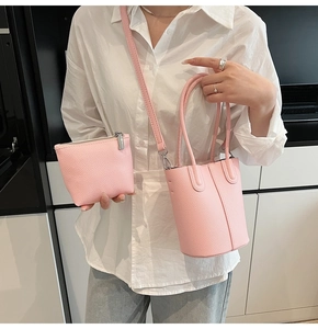 Pink lychee grain leather bucket bag set with matching zipper coin pouch and handle