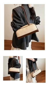 Detail of minimalist cream woven shoulder bag with brown leather trim and slim straps