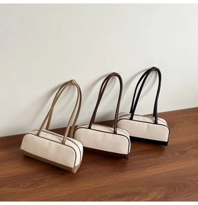 Three stylish canvas and leather Boston bags in coffee, brown, and black colors