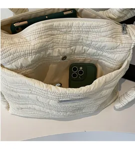 Interior view of beige quilted tote bag showing large capacity and internal pockets