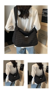 Detail of black wavy quilted tote bag featuring a white square minimalist label