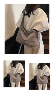 Detailed view of dark grey quilted shoulder bag with wave texture and wide strap