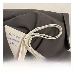 Detail of the white synthetic leather handbag strap with durable metal hardware and stitching