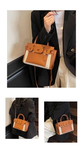Detail of vintage canvas and leather patchwork handbag with textured finish and metal hardware