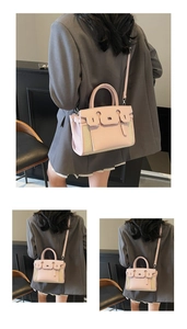 Detail of pink leather and beige canvas拼接 fashion handbag with metal clasp lock