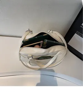 Spacious interior of a cream white PU leather tote bag with tablet and daily essentials