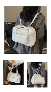 Macro detail of the glossy white PU leather surface and Noronoro embossed logo on the bag