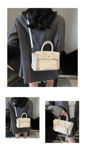 Detail view of structured ivory tote with adjustable strap and pebble grain texture