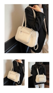 Macro detail of creamy white faux leather shoulder bag featuring embossed Noronoro logo