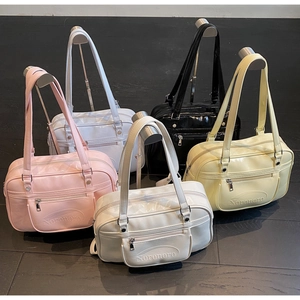 Row of versatile faux leather JK style handbags in five vibrant colors hanging on metal racks