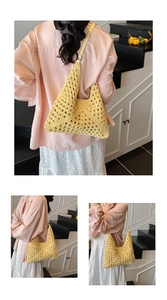 Detail view of yellow crochet straw tote with bohemian woven hollow pattern and shoulder strap